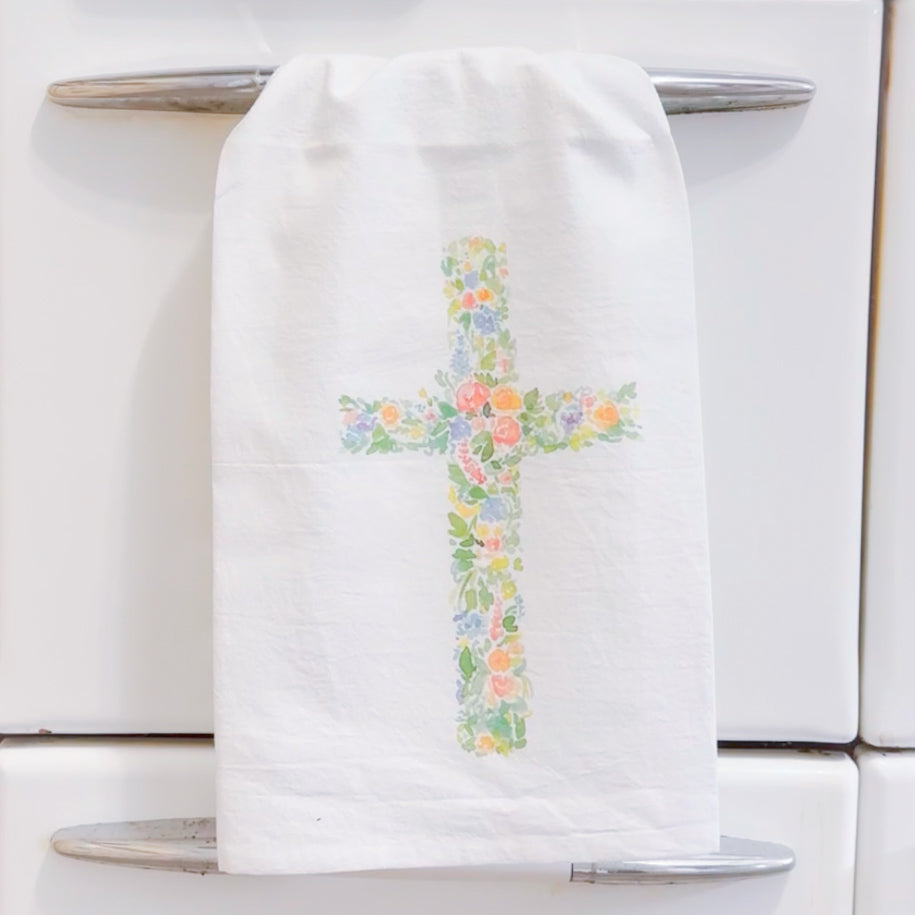 white kitchen towel with a watercolor floral christian cross on it