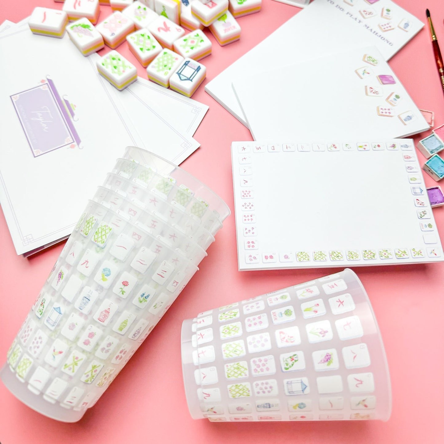 Cups alongside a game of Mahjong
