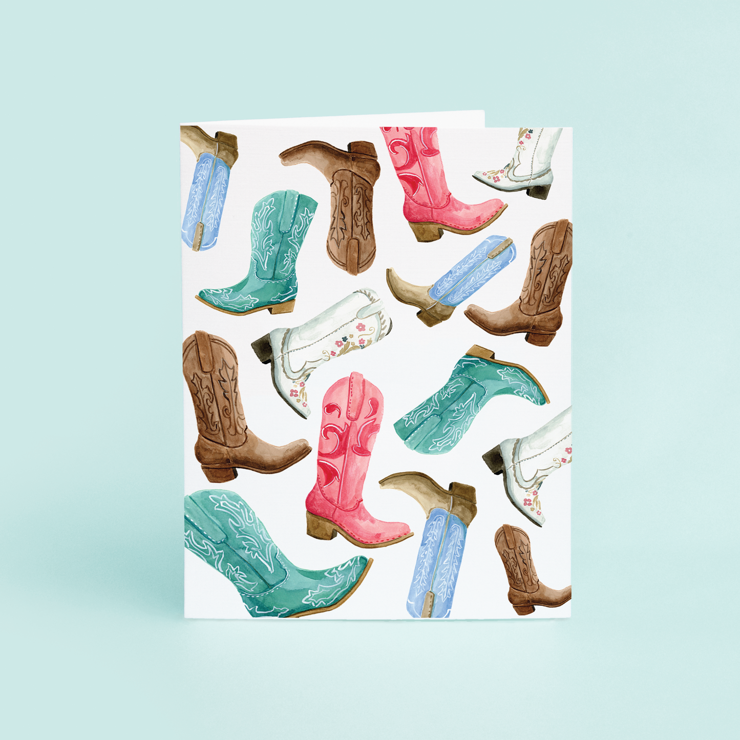 western inspired watercolor cowboy boots. pink, green, blue, white, and brown boots on a white card.