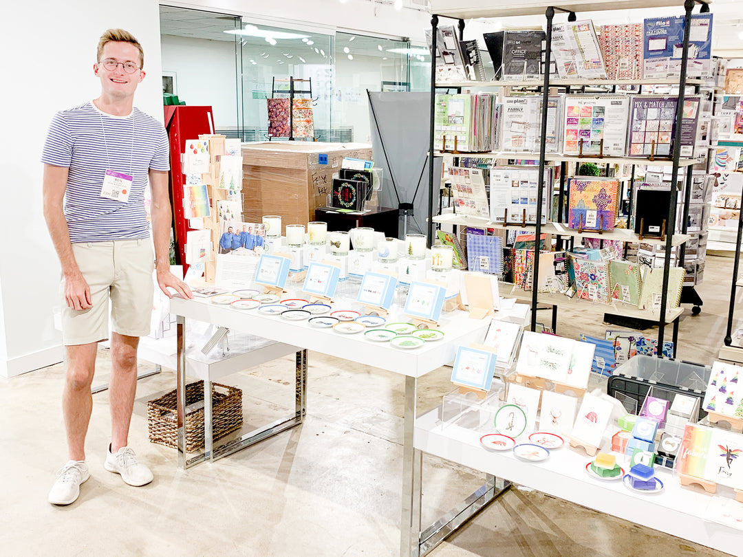 Ben Paladino at Dallas Market Gift Show with artistic greeting cards, candles, soaps and coasters