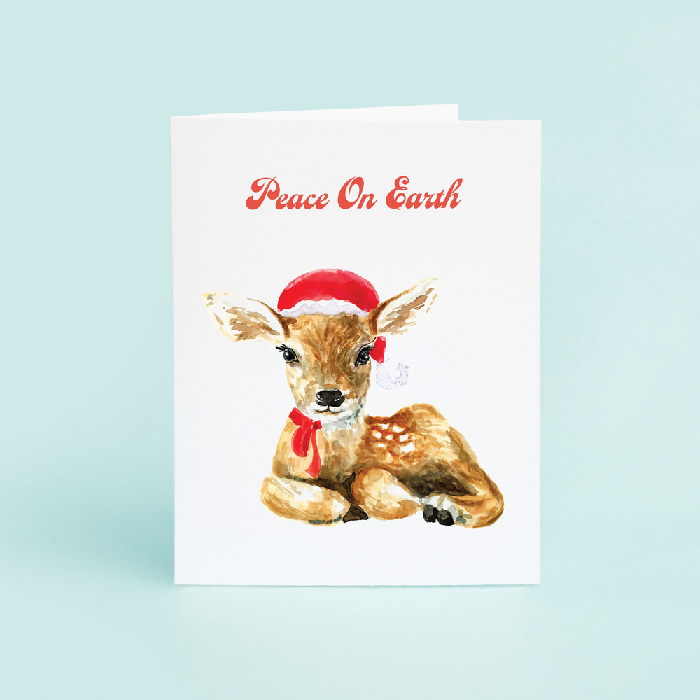 Peace on Earth saying with a fawn with a santa hat on.