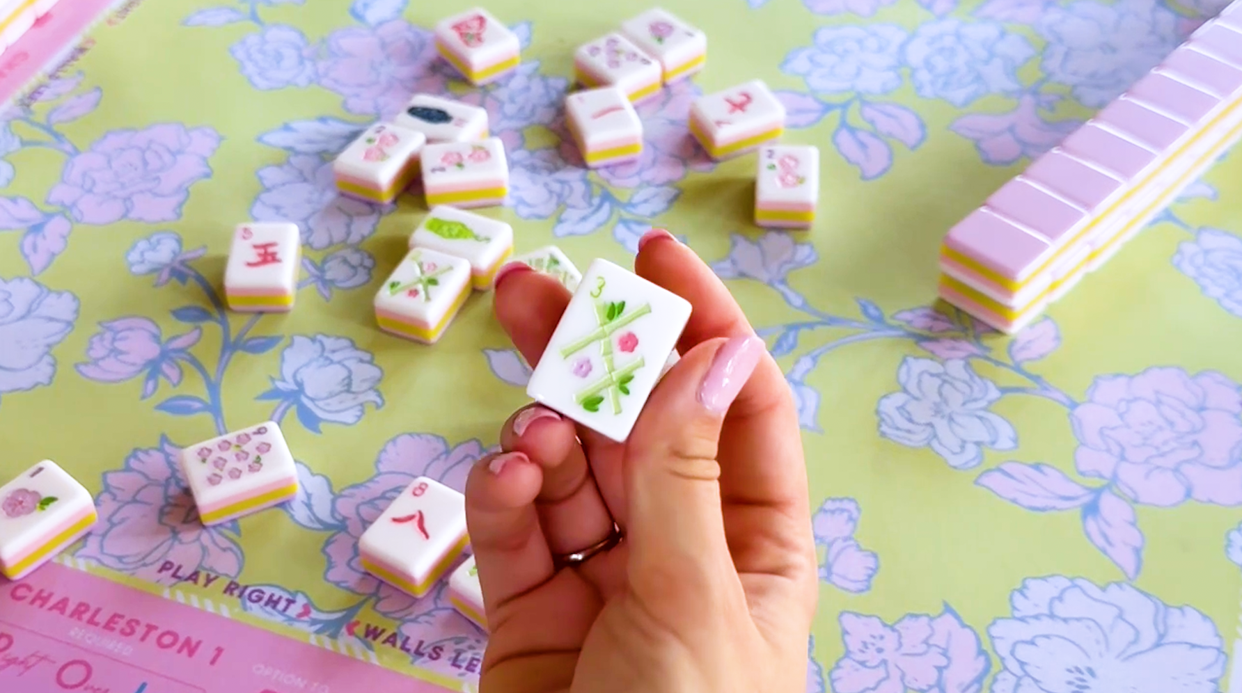 Video of woman and man setting up mahjong table