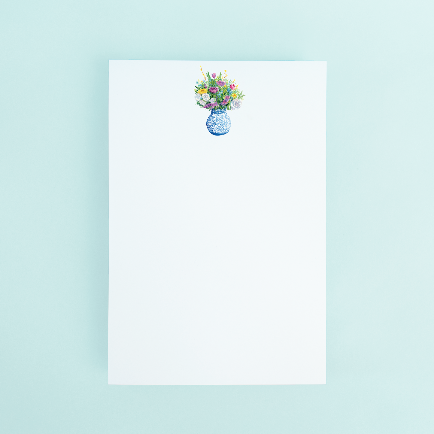 A notepad with a floral bouquet illustration at the top, on a plain background.
